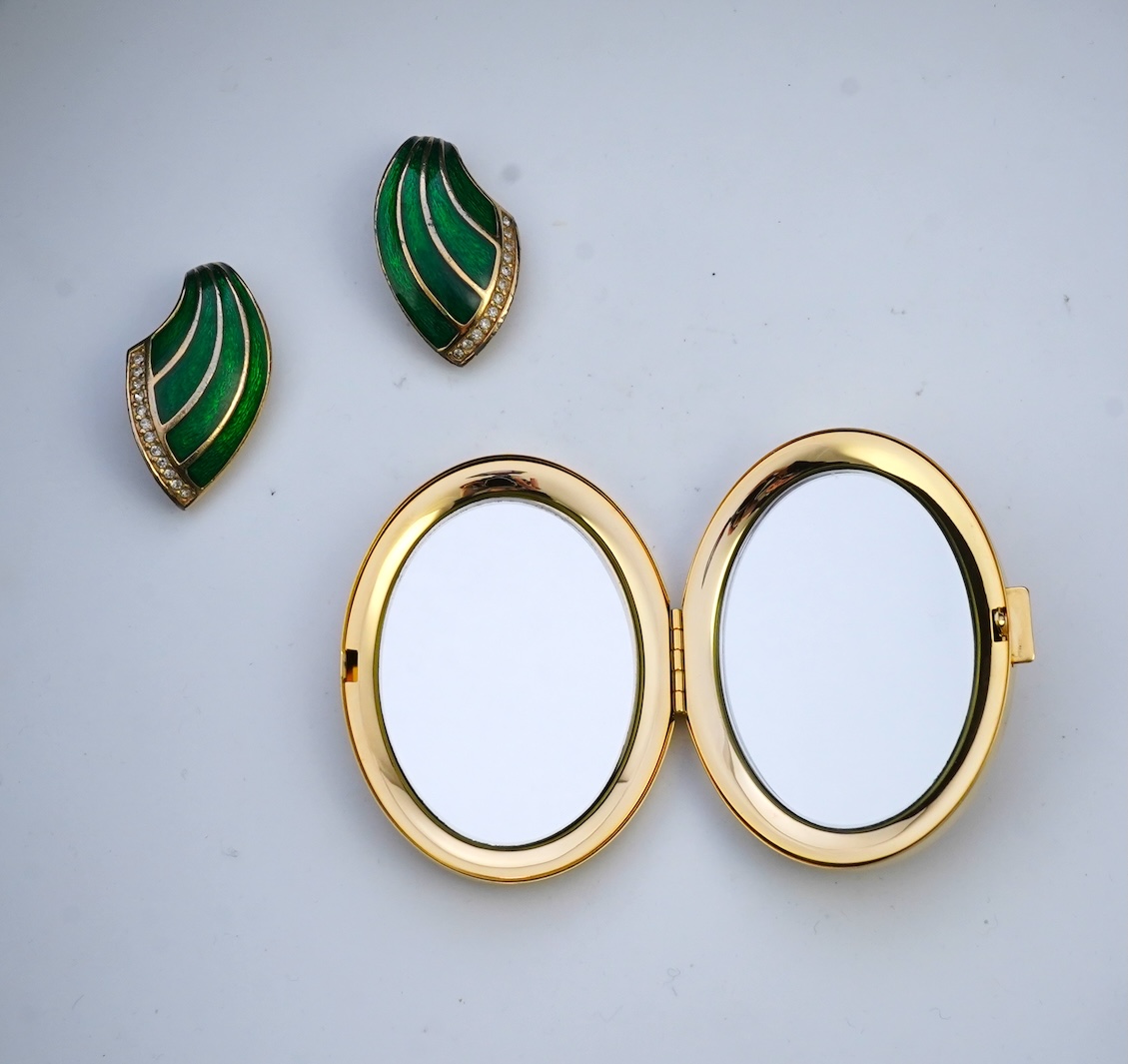 A pair of Christian Dior vintage earrings and compact mirror.